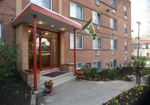 Entrance to a residential building with a welcome flag at Eola Park apartments for rent